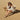 Woman sitting on a folding chair in the sand wearing black Archies flip flops.
