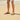 Person wearing charcoal Archies flip flops on a sandy beach