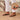 Person wearing crystal black Archies flip flops on a wooden floor with a close-up of the crystal on the flip flop thong