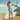 Woman standing poolside on a sunny day wearing charcoal Archies flip flops