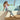 Woman sitting by a poolside wearing crystal black Archies flip flops