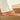 Person wearing orange 
Archies flip flops on wooden steps