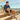 Man sitting on steps outdoors wearing sky blue Archies flip flops