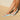 Person wearing sky blue Archies flip flops on a wooden deck