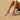 Person wearing white Archies flip flops on a sandy beach