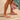 Person wearing crystal pink Archies flip flops on a wooden floor with a close-up of the crystal on the flip flop thong